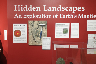 a picture of the exhibit as shown on a red wall