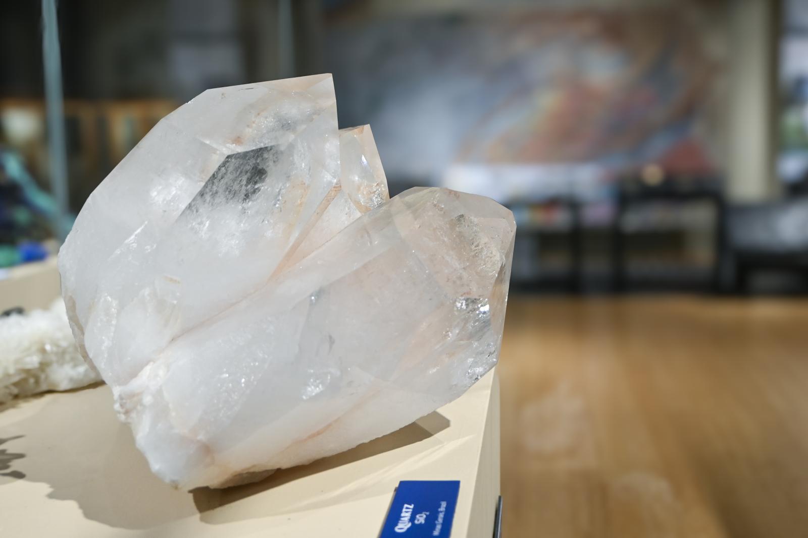 Large quartz crystal on display in museum gallery