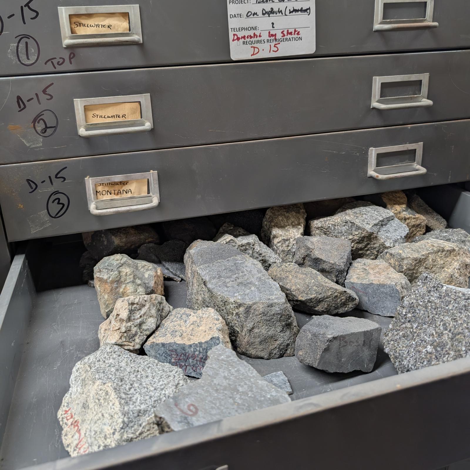 grey metal drawer with grey rock samples 