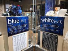 Large blue and white minerals in an exhibit case with labels