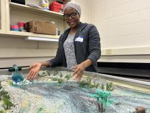 A student works with a stream table in a lab